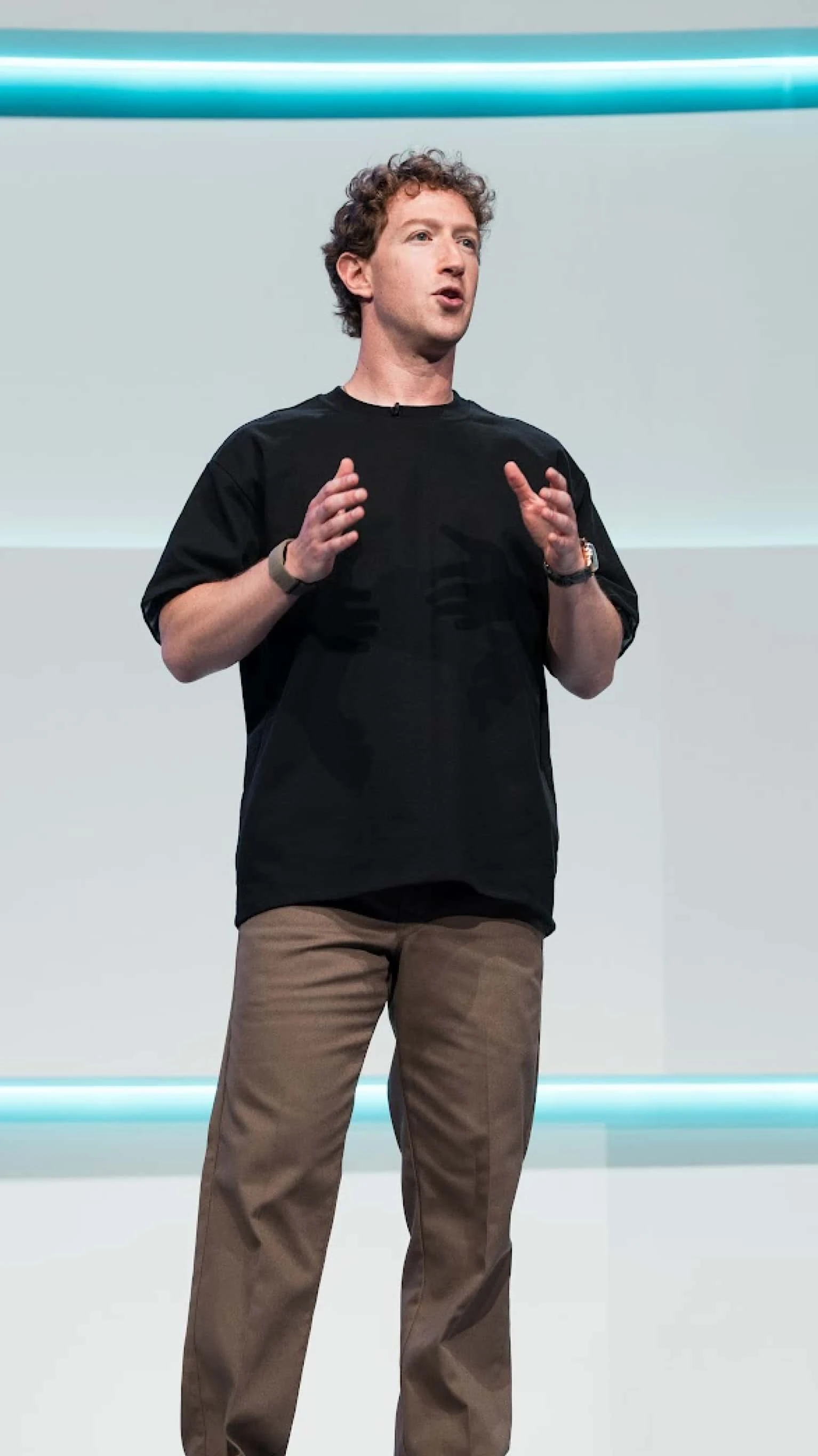 Mark Zuckerberg in black t-shirt speaking on stage