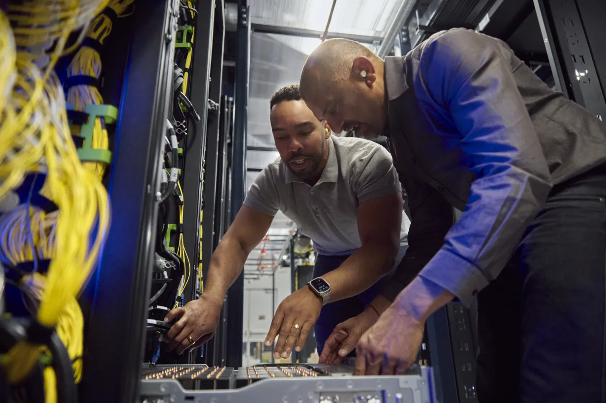 Technical sourcing manager Fangran X. collaborating with a Meta teammate in a lab.