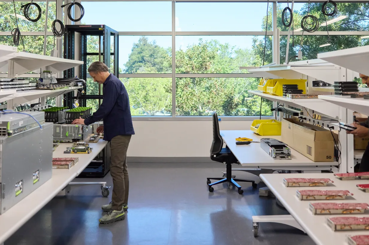Technical sourcing manager Fangran X. collaborating with a Meta teammate in a lab.