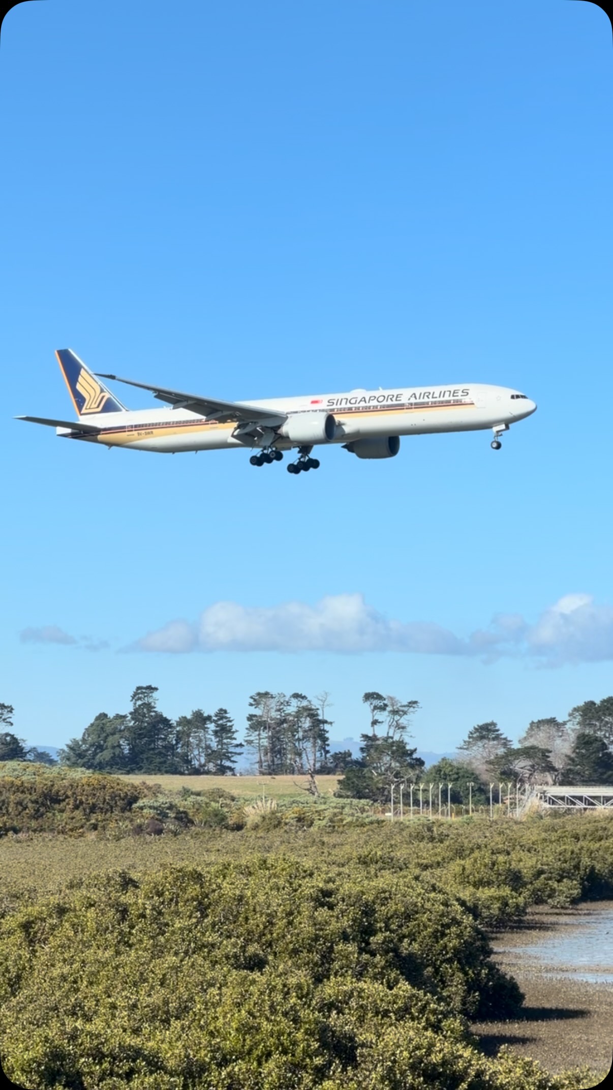 A Singapore Airlines Boeing 777-300ER lands on Runway 23L at