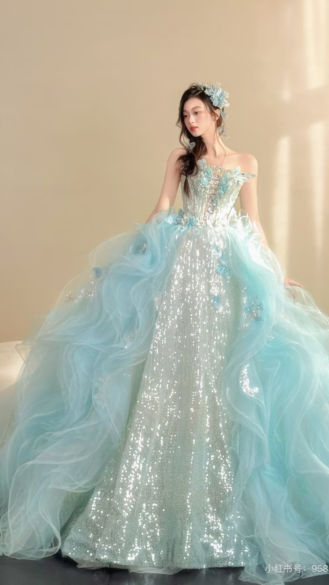 A vision in ice blue. ✨, Where shimmering sequins meet cascading clouds of tulle, creating a gown that feels like it belongs in a fairytale. 💙, Every detail is crafted to make you shine on your most 