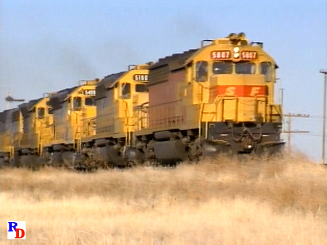 Five Santa Fe locomotives, including a B-unit trailing, take a