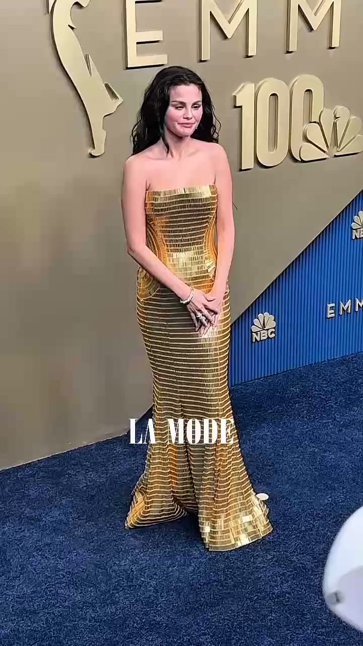Golden and glowing! , Selena Gomez stepped onto the 78th Emmys red carpet looking every bit the star in this breathtaking gold dress., A timeless red carpet moment or too much sparkle? We want to 