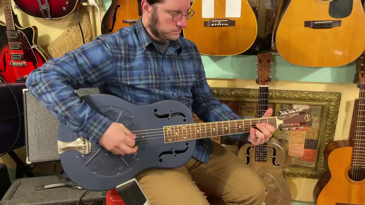 This is a 2005 National Delphi resonator guitar in a slick blue
