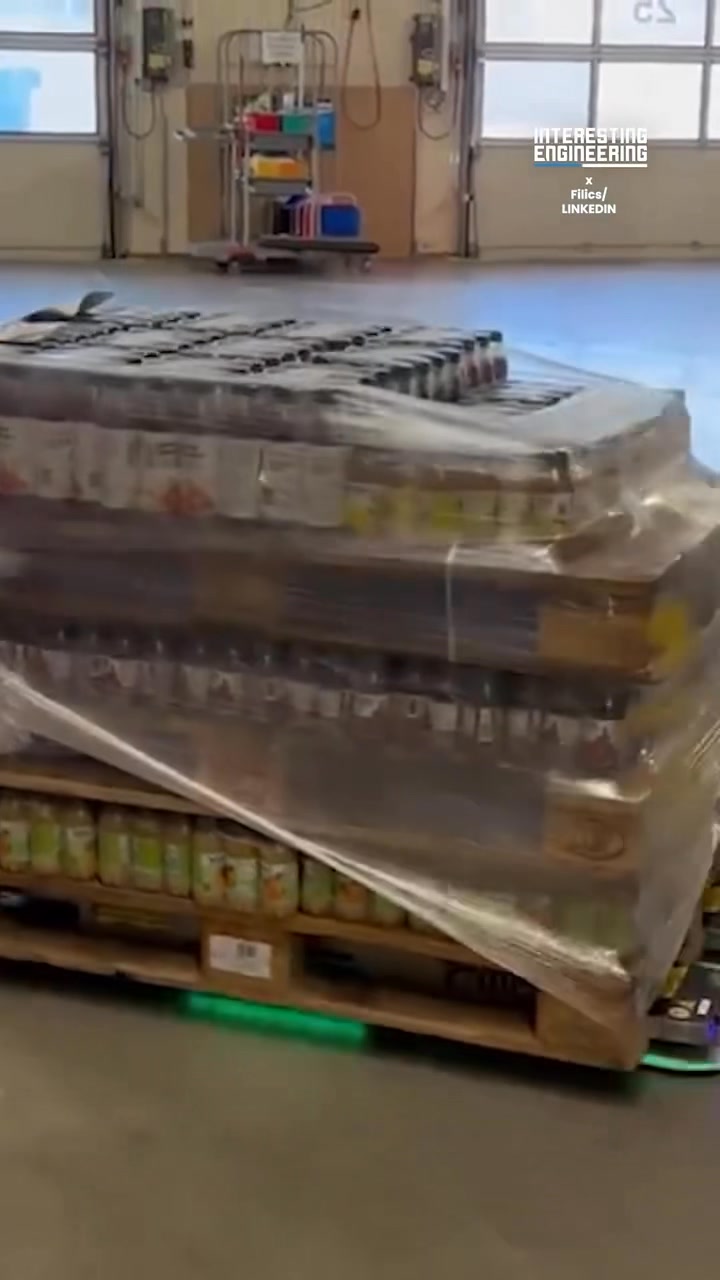 Watch as two autonomous warehouse robots team up to seamlessly lift and ...