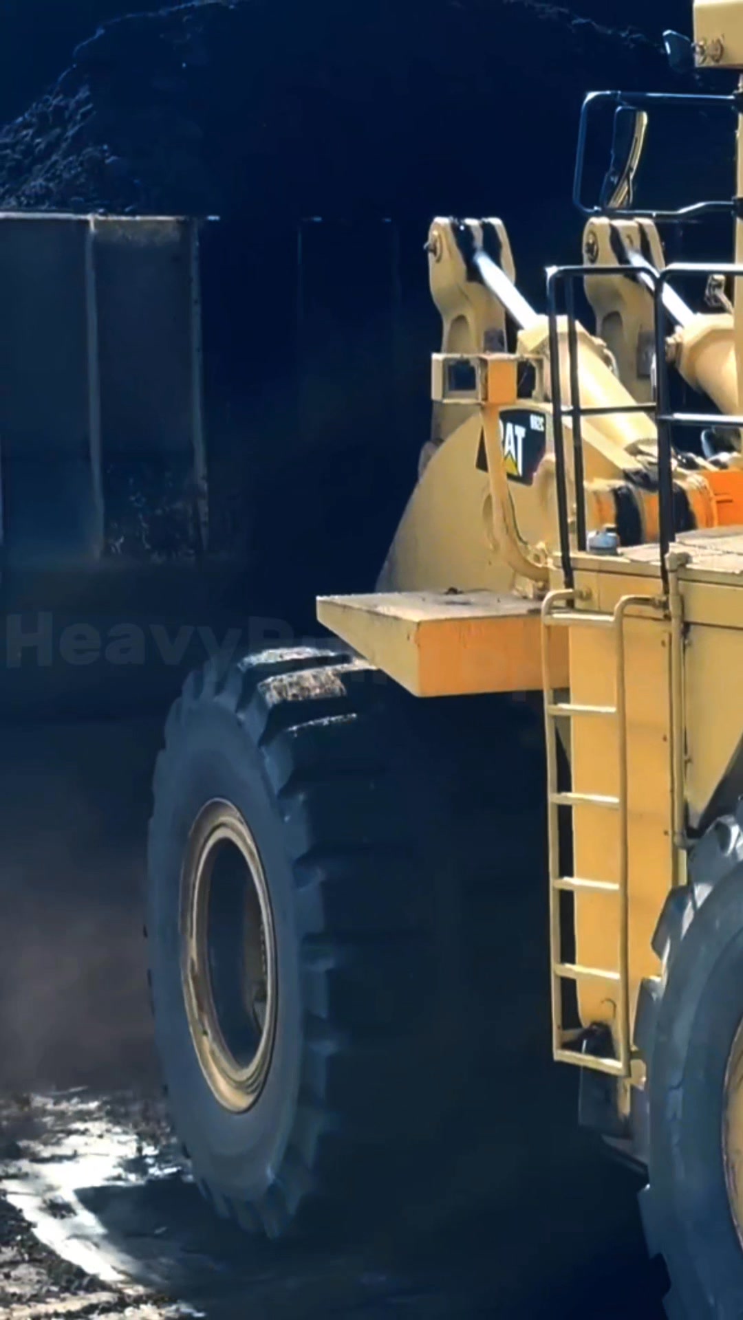 The CAT 992C wheel loader demonstrates its massive capacity by filling ...