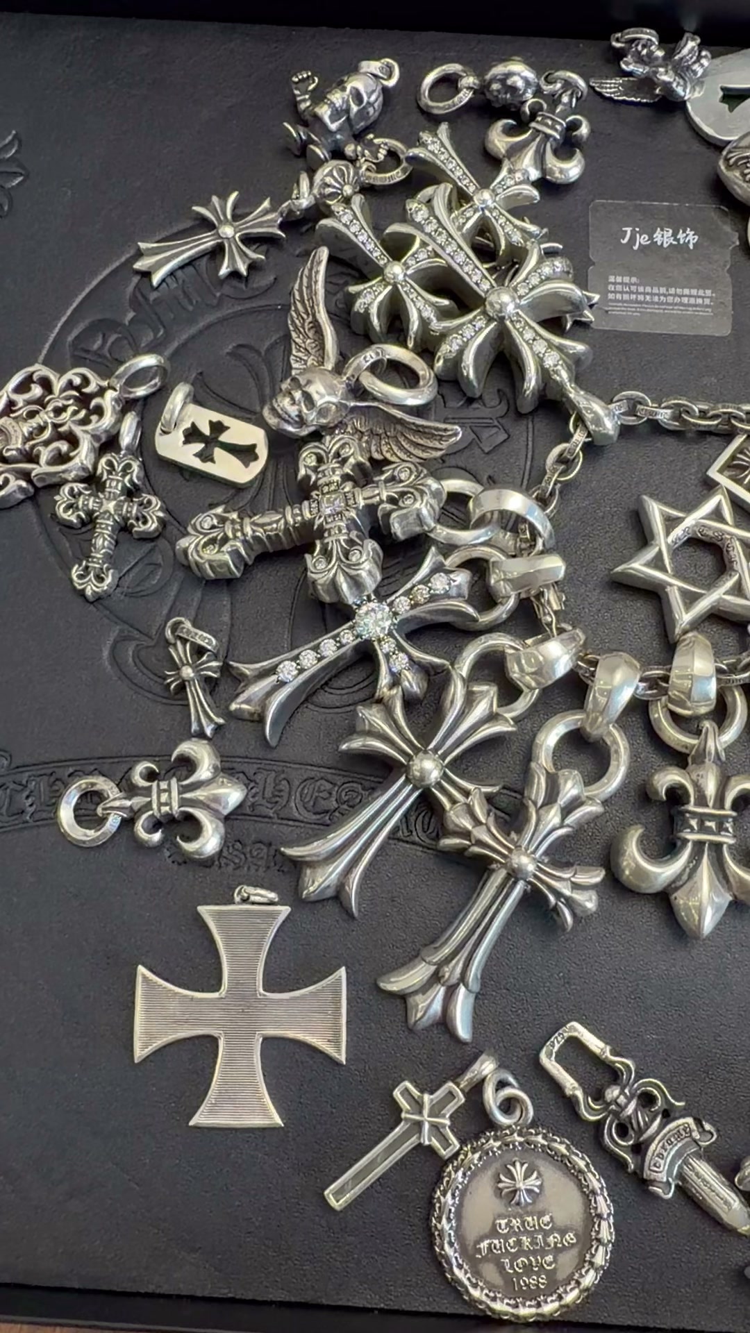 Features detailed cross‑flower engraving on lobster snap and chain