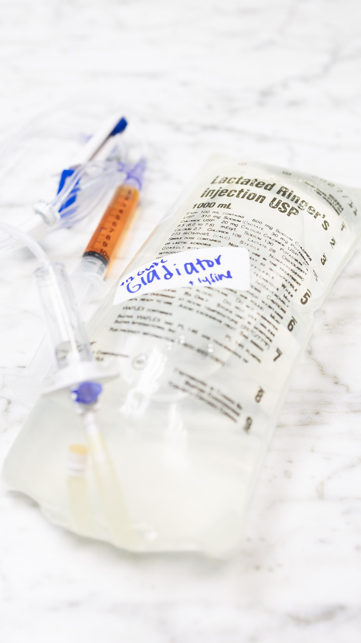 Ever wonder what's in a Gladiator drip? 💧, Come behind the scenes with one of our nurses, Savannah, as she builds one of our most popular IVs, complete with a Lysine add-on for even more wellness 