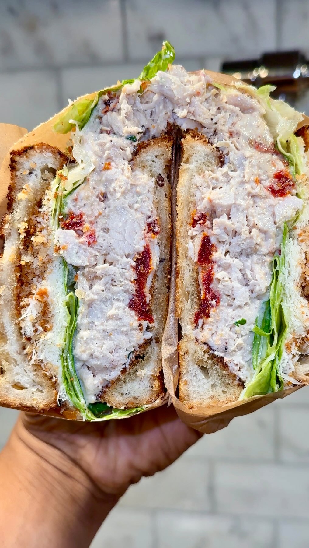Ate this chicken Caesar sandwich like it owed me money 😩😂🔥 Hand shredded roasted chicken breast, anchovy and tarragon Caesar dressing, sun-dried tomatoes, caramelized shallots, romaine lettuce, grated 