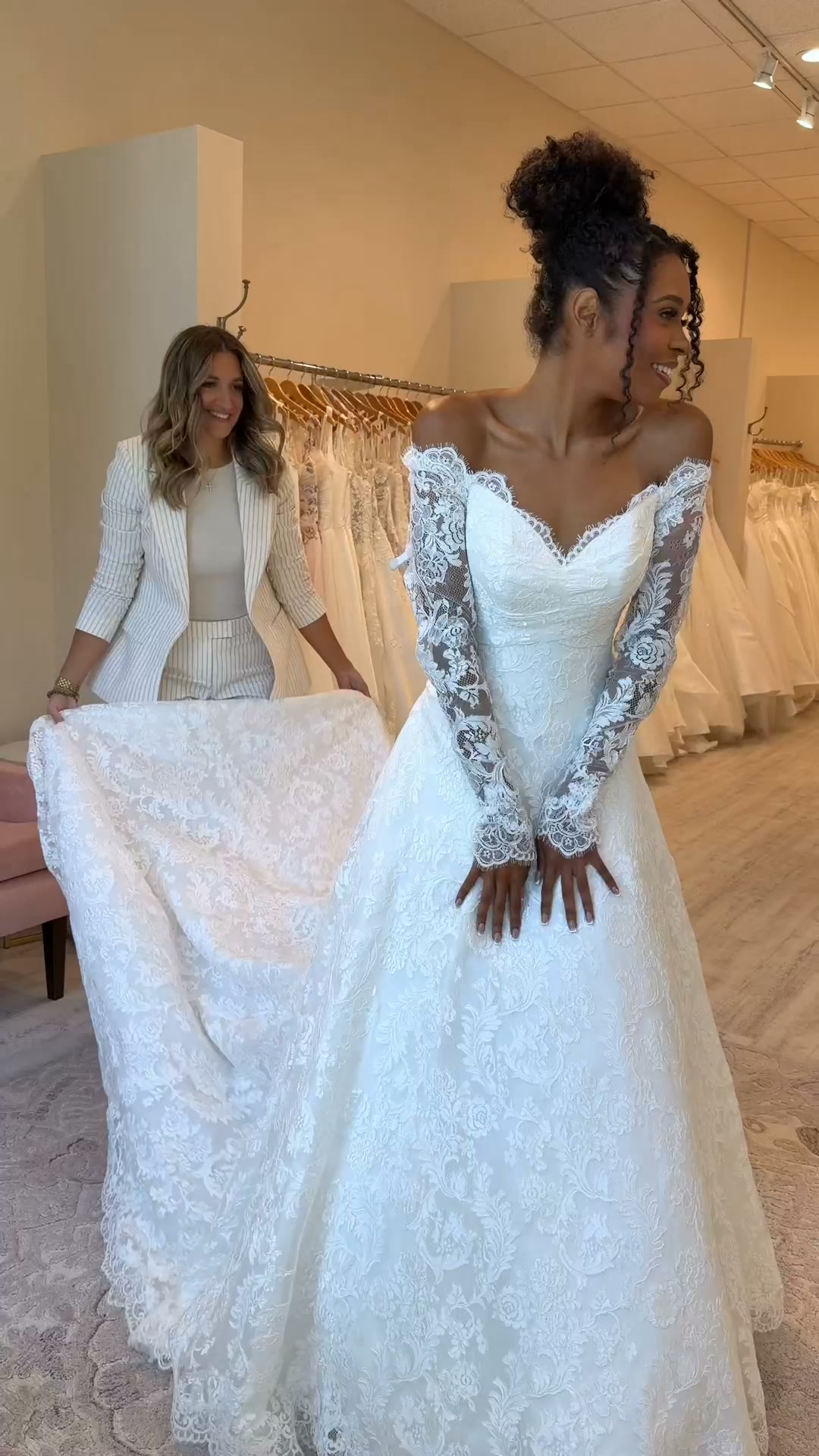 Romantic lace with a little something extra. 🤍, An off-the-shoulder neckline, delicate long sleeves, and lace from top to bottom make this gown one you have to see up close., Ready to find your dress? 