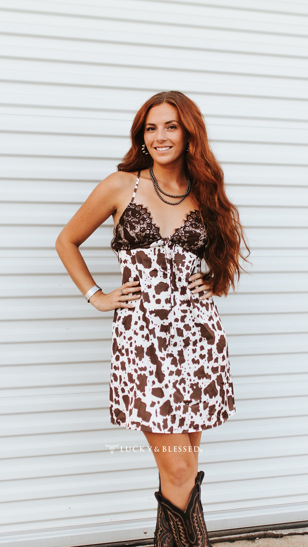 Cute cowgirl print mini dress! 🤠, Tiered ruffles and flowy fit! ✨, •, Cow Print Satin Lace Trim Cami Mini Dress, •, Product code: DR944-COW, •, #Luckyandblessed #luckyandblessedobsessed #dallas 