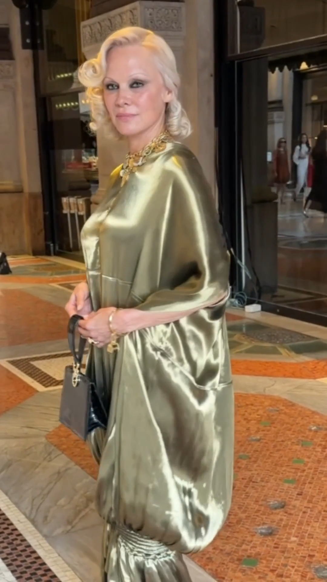 pamela anderson gold dress has arrived at the Galleria for #VogueWorld: Milan. Head to the link in the comments to see every red carpet arrival thus far. | Vogue midi dress pattern