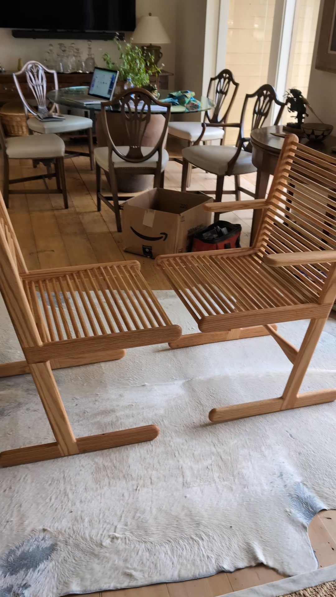 Who designed full-size rosewood chairs with metal dowels?