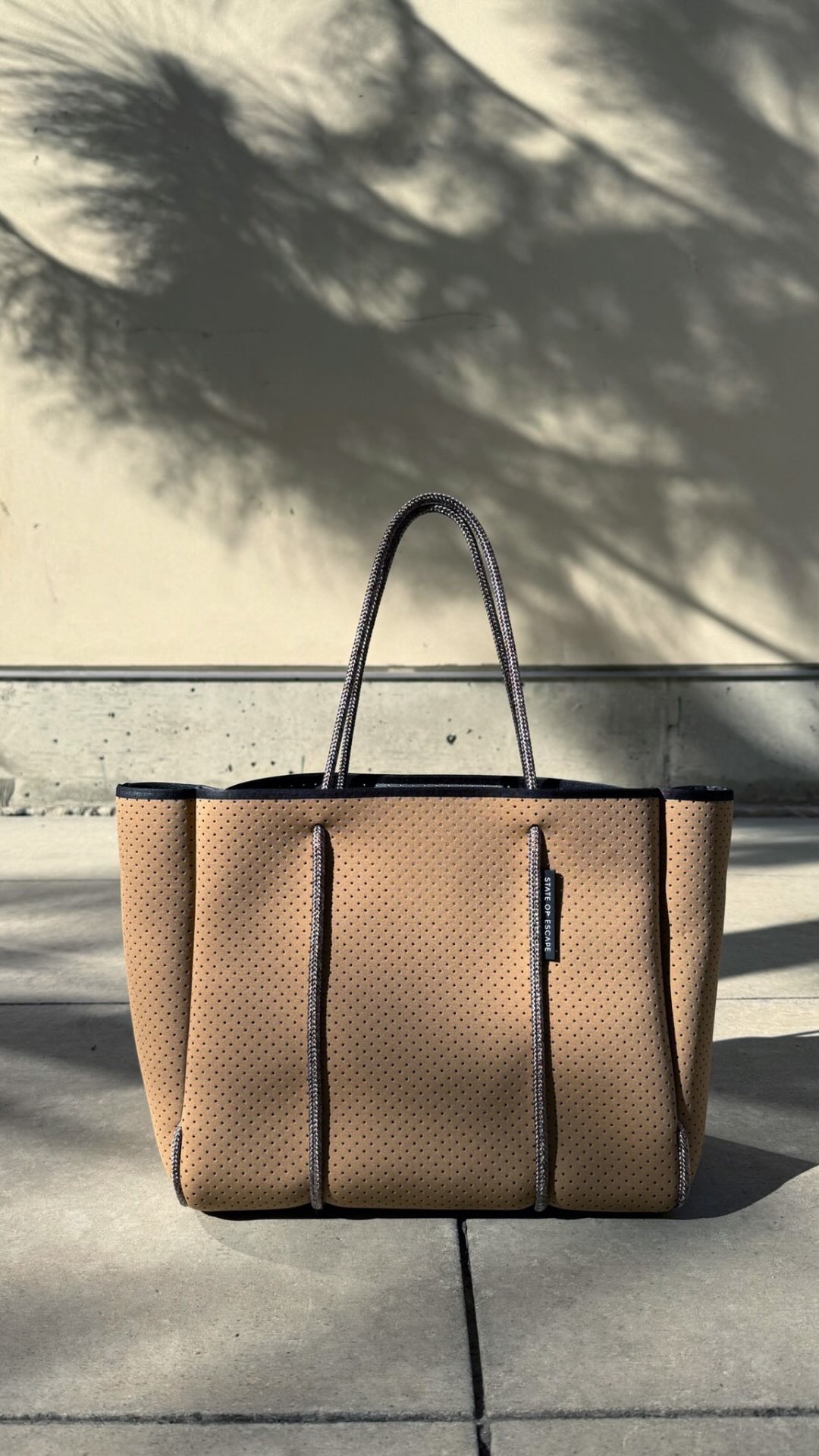 The Flying Solo tote in caramel / steel, is a compact version of