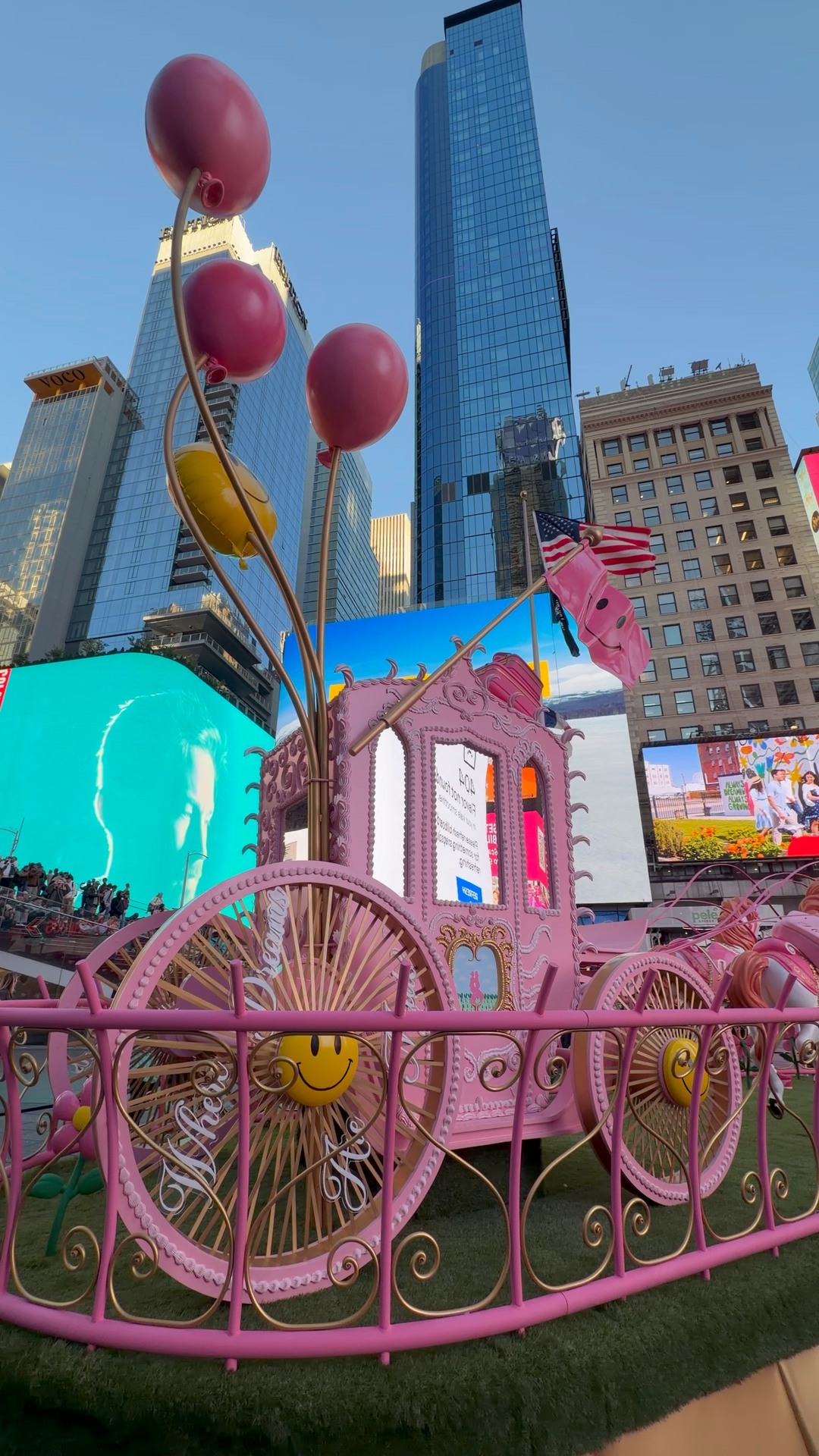 The pink carriage parked under the billboards isn't a fairytale