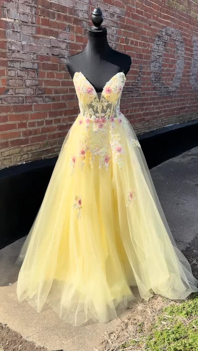 prom flowers for a gold dress How heavenly sweet is this yellow gown complete with dainty #centralillinois #promdress #trend #yellowdress💛 #prom2026 | Ooo La La Brides and Prom Queens sparkly blue dress