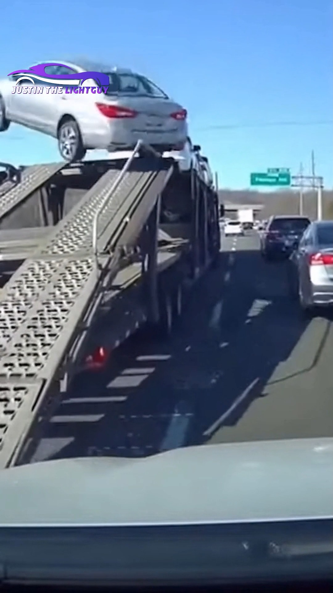 A sedan accelerates onto a lowered car hauler ramp, becomes airborne ...