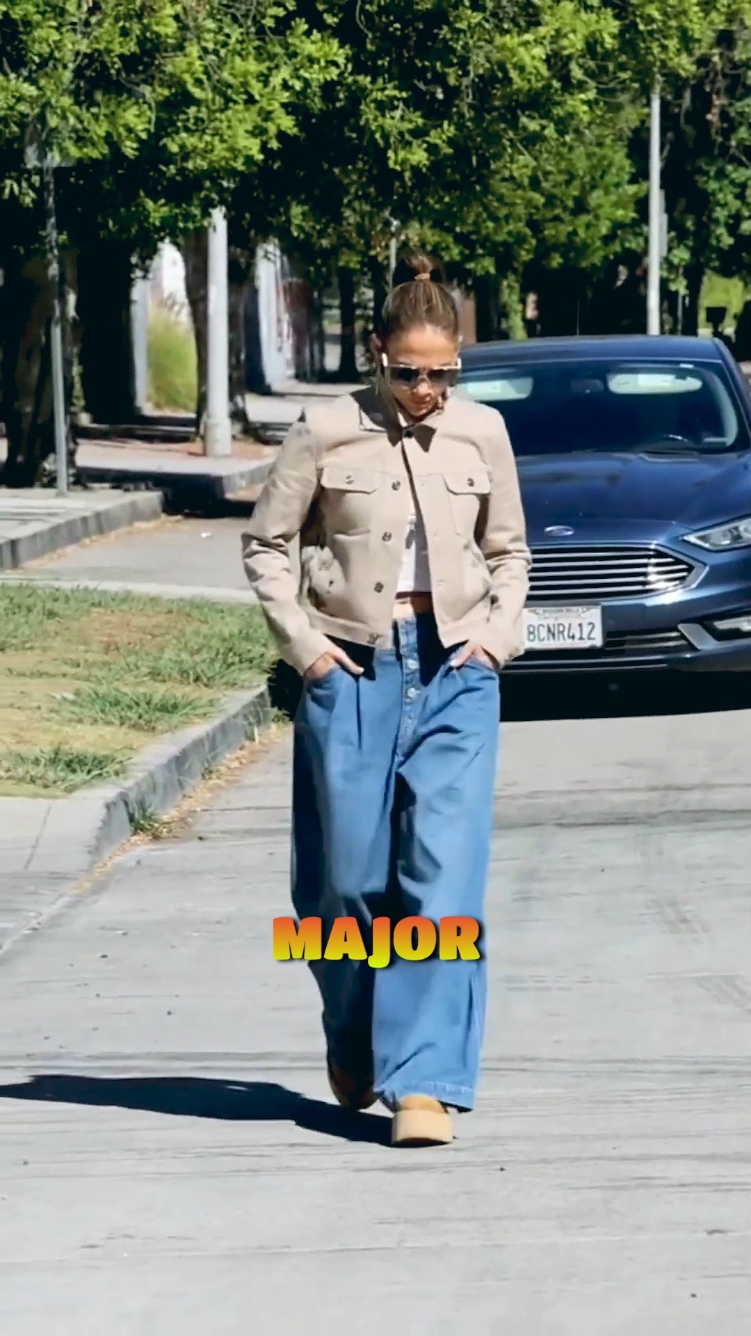 Jennifer Lopez surprised fans by trading her glamorous red carpet gowns for Gen Z's favorite wide-leg jeans trend, paired with a striped button-down and cozy tweed blazer for a casual LA outing. The 