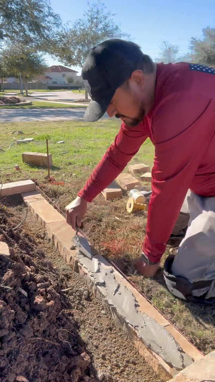 Retaining wall blocks flowerbed borders using limestone blocks and caps ...