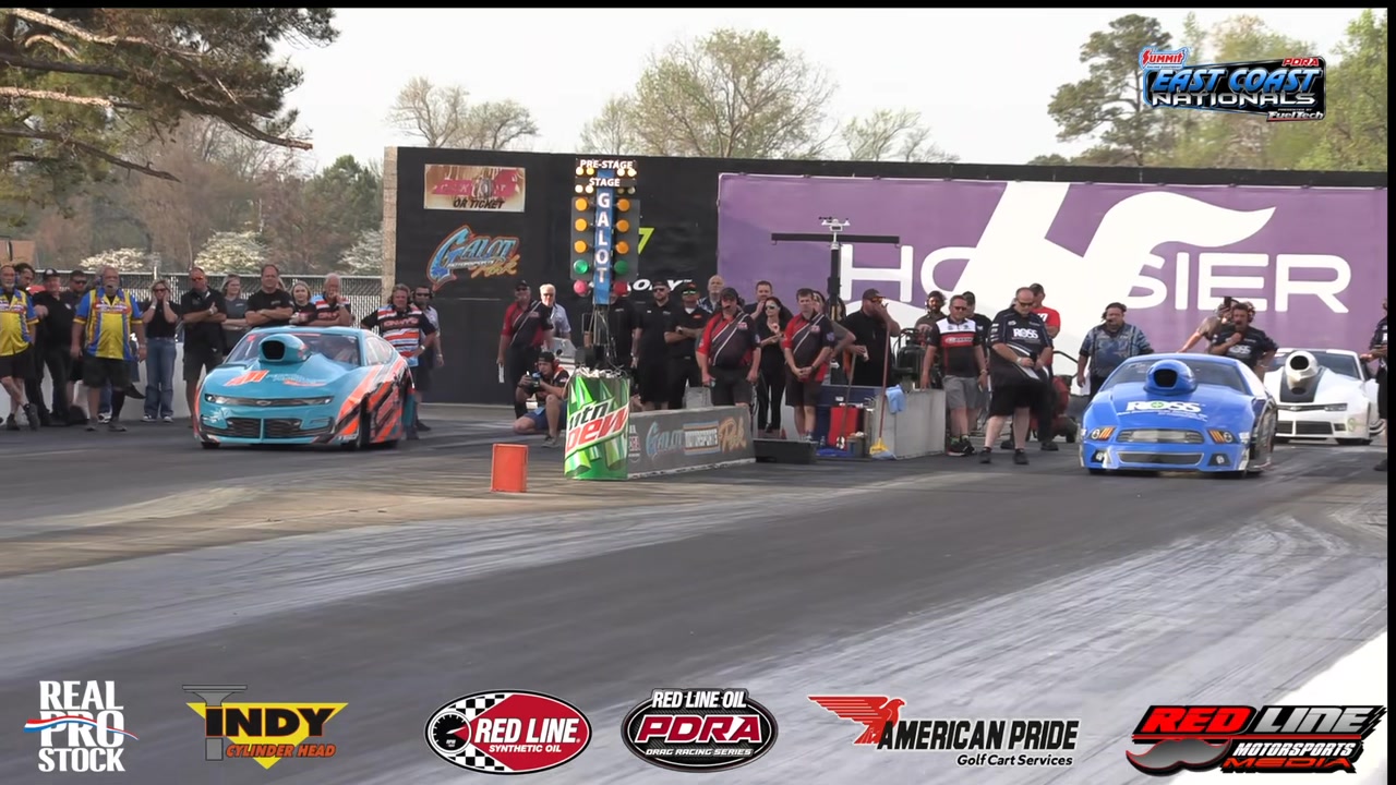 Chris Powers with the Powers Xtreme Motorsports team hold the ...