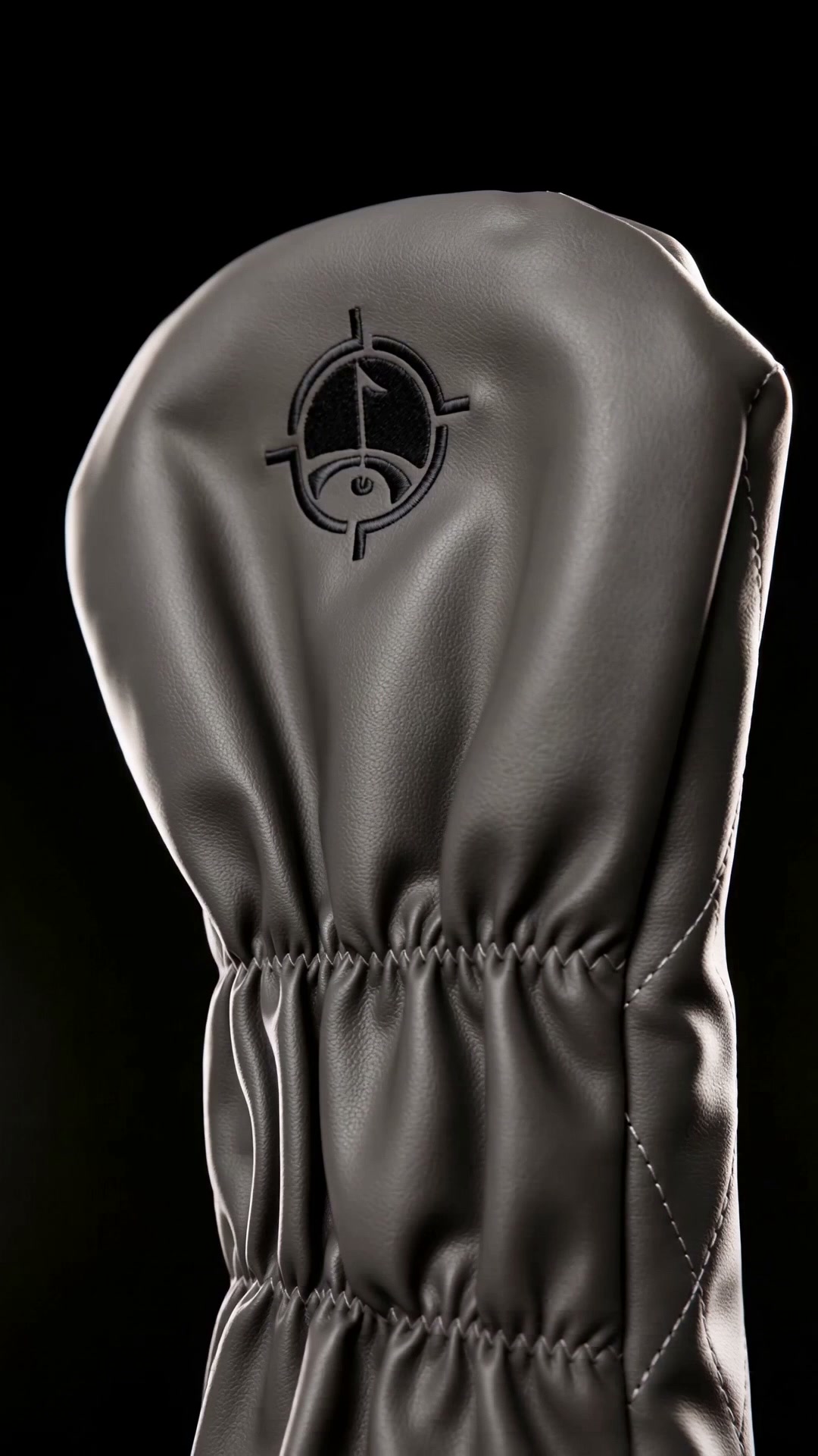 Gunmetal synthetic leather. Two words in black thread on a black