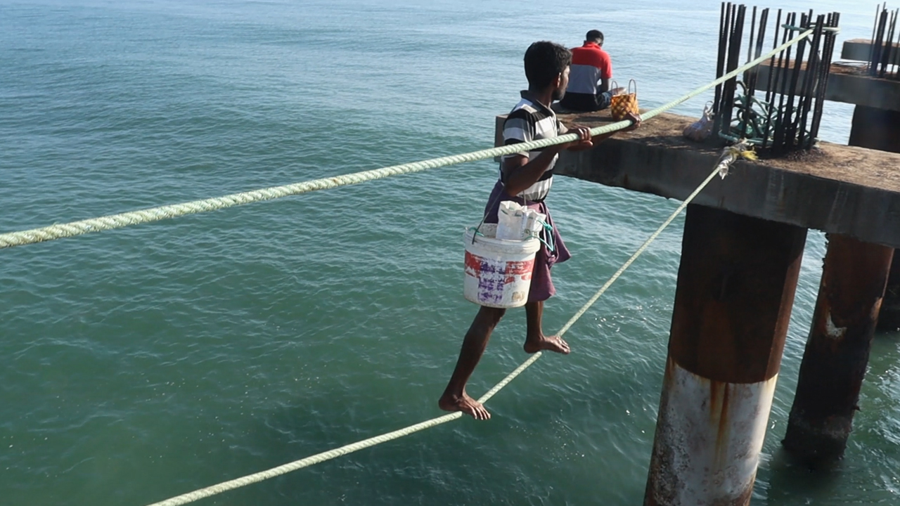Fishermen risk their lives by walking from one 25 feet high bridge to ...