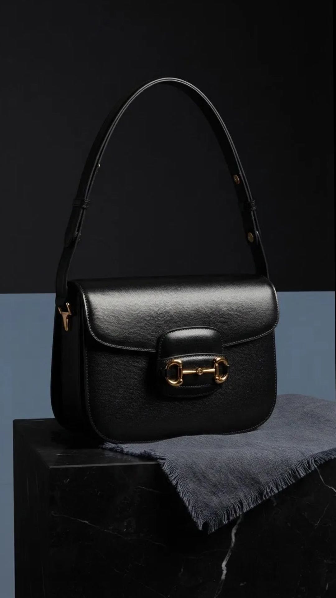Black textured leather. Gold horsebit hardware. A direct line from 