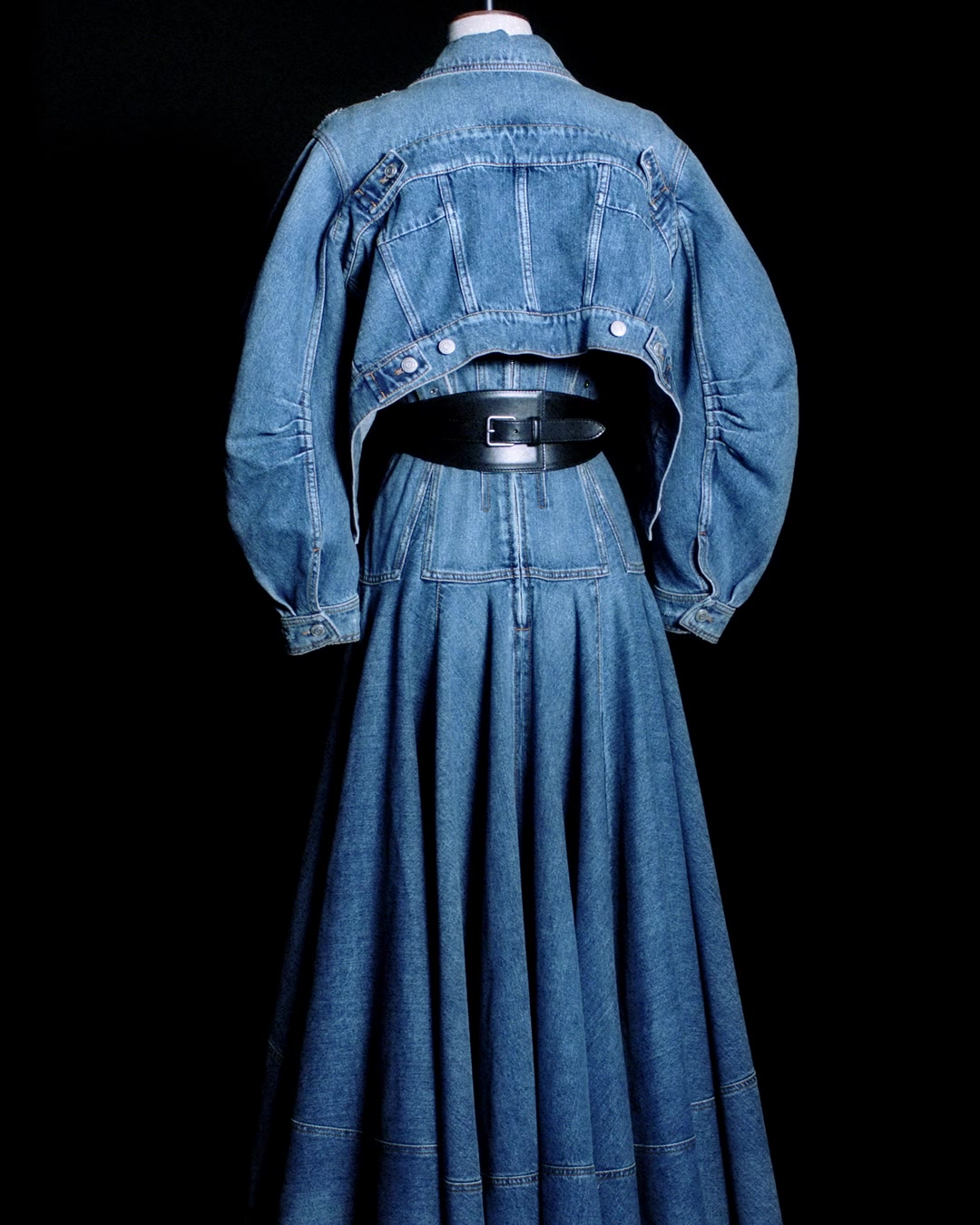 A denim corset dress with a kickback skirt, a black belt featuring
