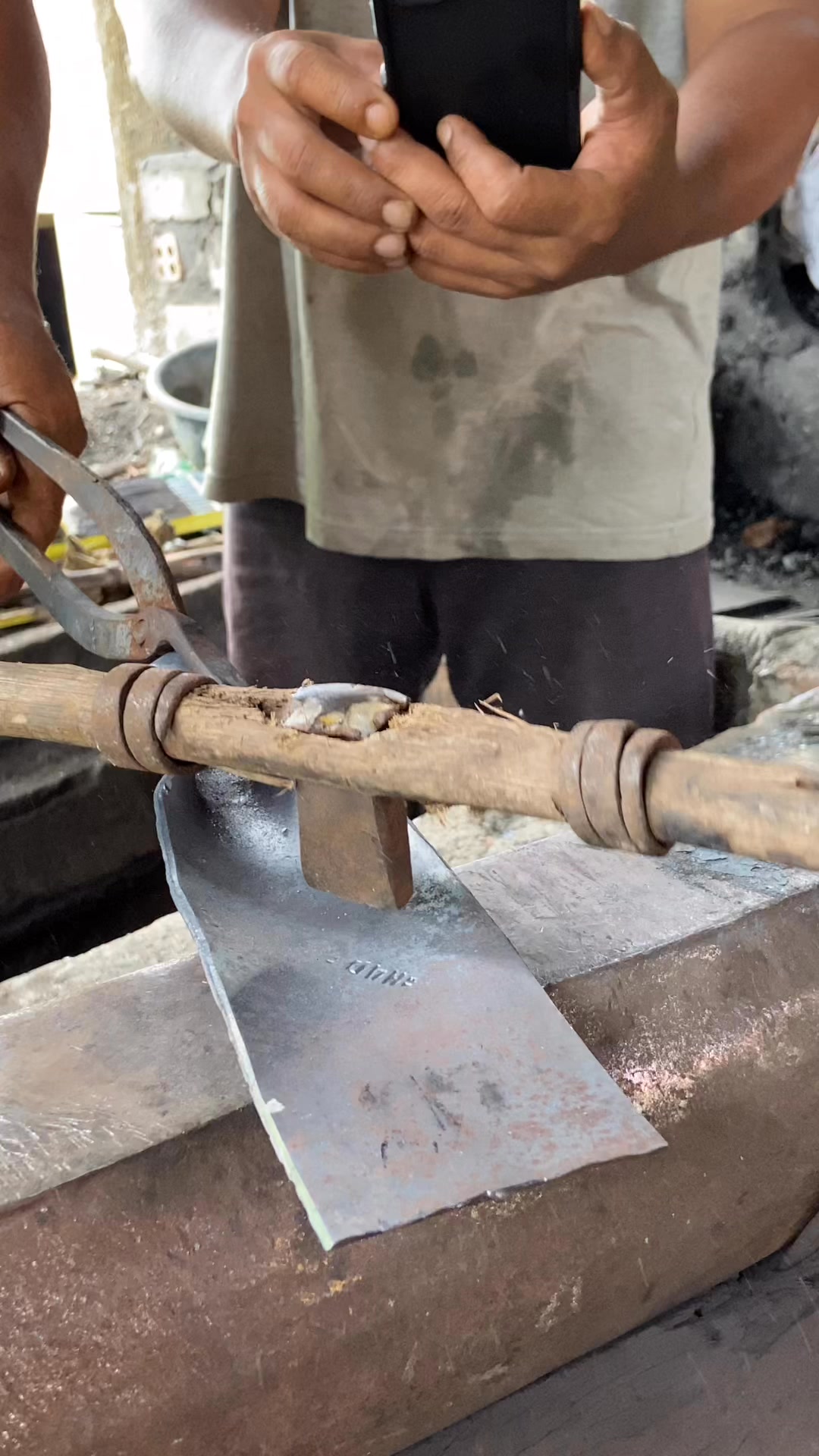 the process of making a crowbar, an agricultural tool for digging the ...