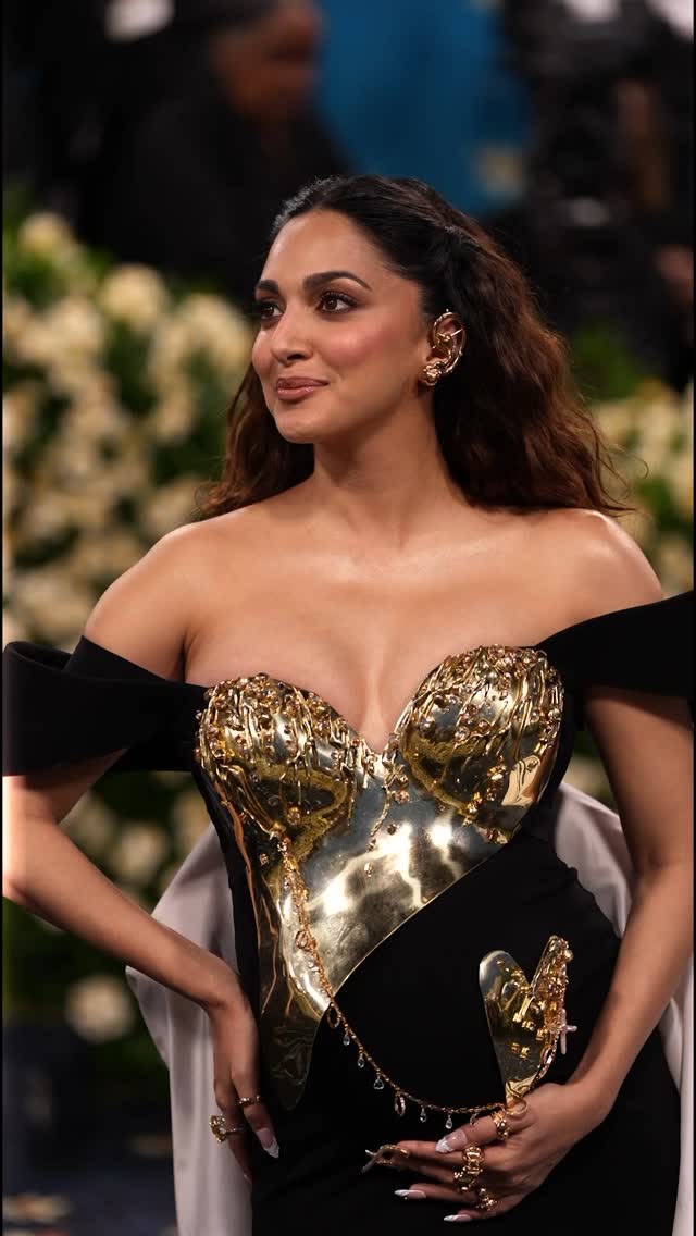 kiara advani gold dress makes her Met Gala debut in Bravehearts by Gaurav Gupta — a sculptural couture look inspired by Black dandyism and created before her journey into motherhood. The ensemble pays homage to party wear kiara advani gown