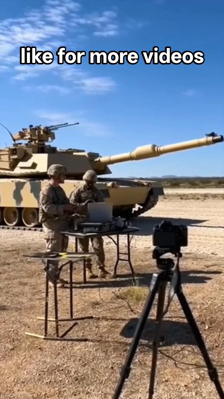 A tank weapons test is conducted in an open field. Soldiers check ...
