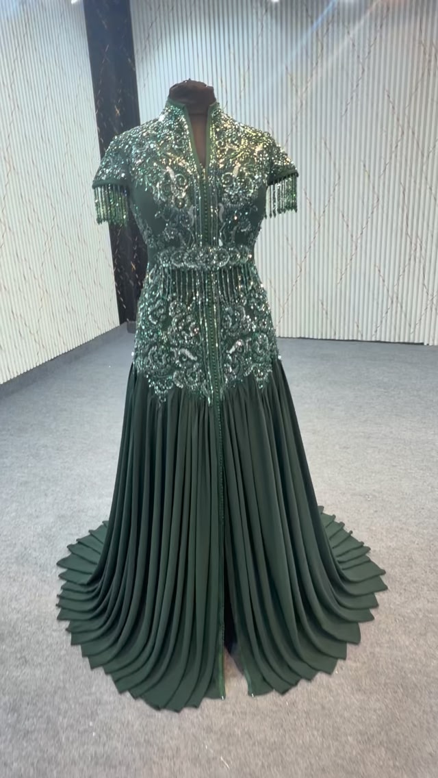 caption for green dress instagram Premium Caption, Luxury in every thread 💚✨, An exquisite emerald couture gown, richly adorned with green and silver hand embellishments, featuring intricate cut dana work, shimmering x-styleCode:PGFAB072