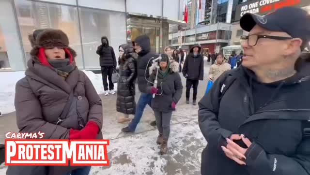 Woman in a trapper hat asks the man attempting to confront Antifa ...