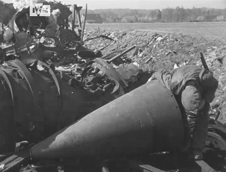 British troops examine and pose next to a V2 rocket after the train ...