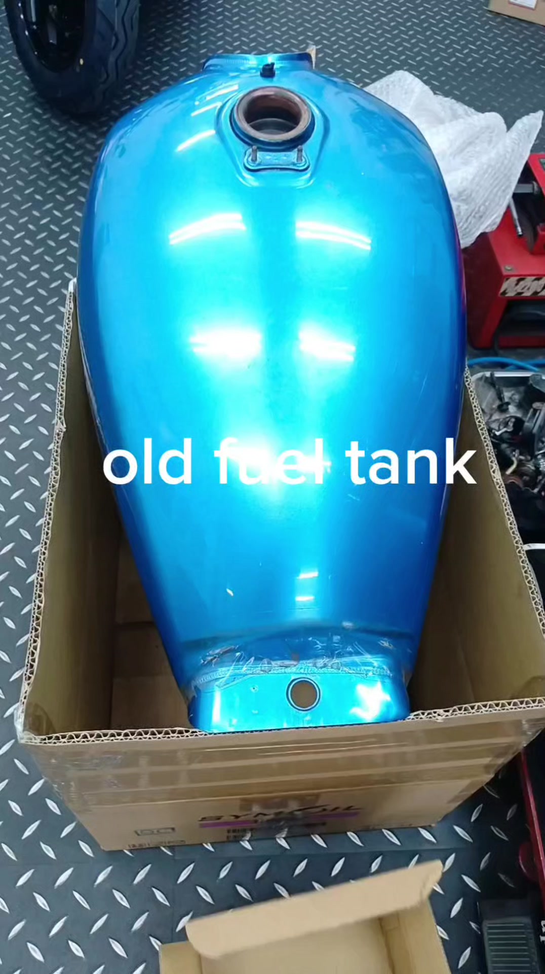 Weathered metal motorcycle fuel tank in a brown finish. This