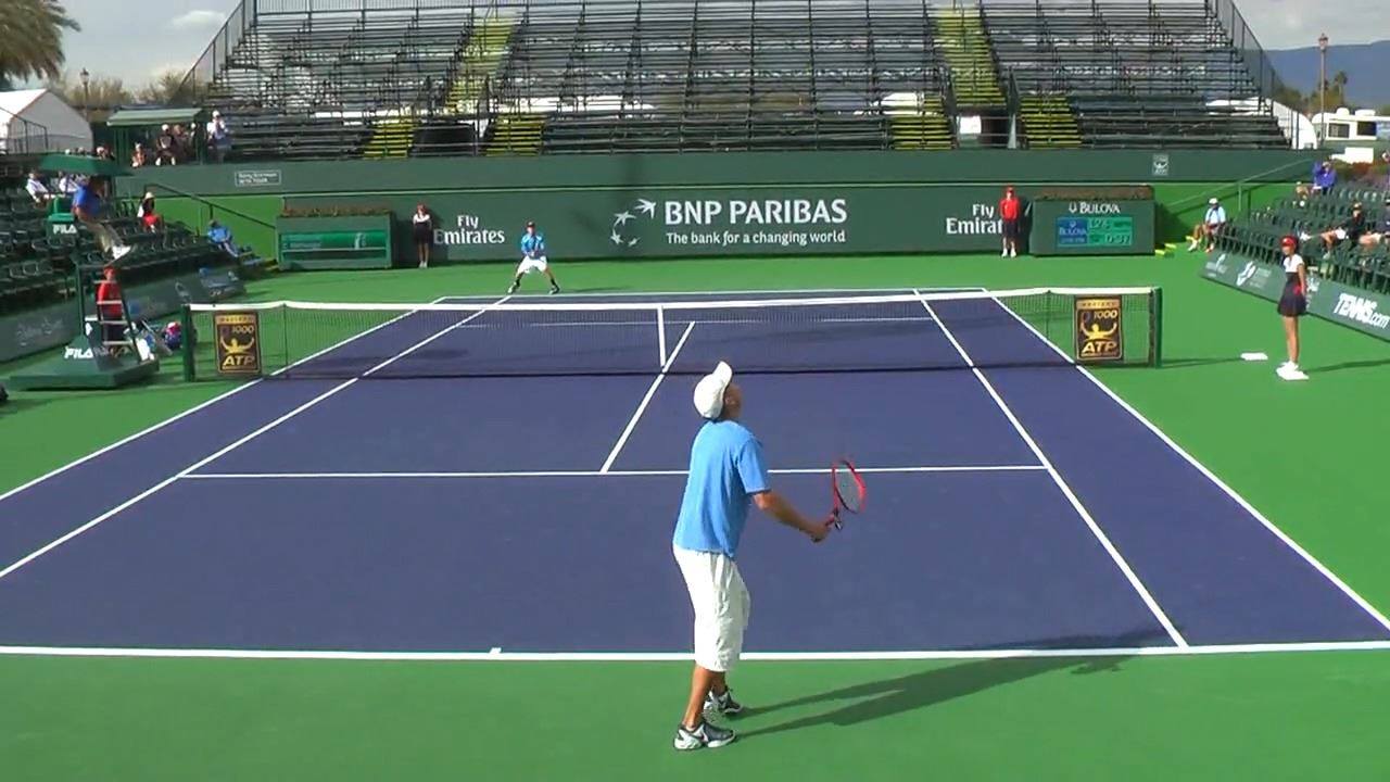 Natural Tennis player and owner Brian Battistone hitting the jump serve ...
