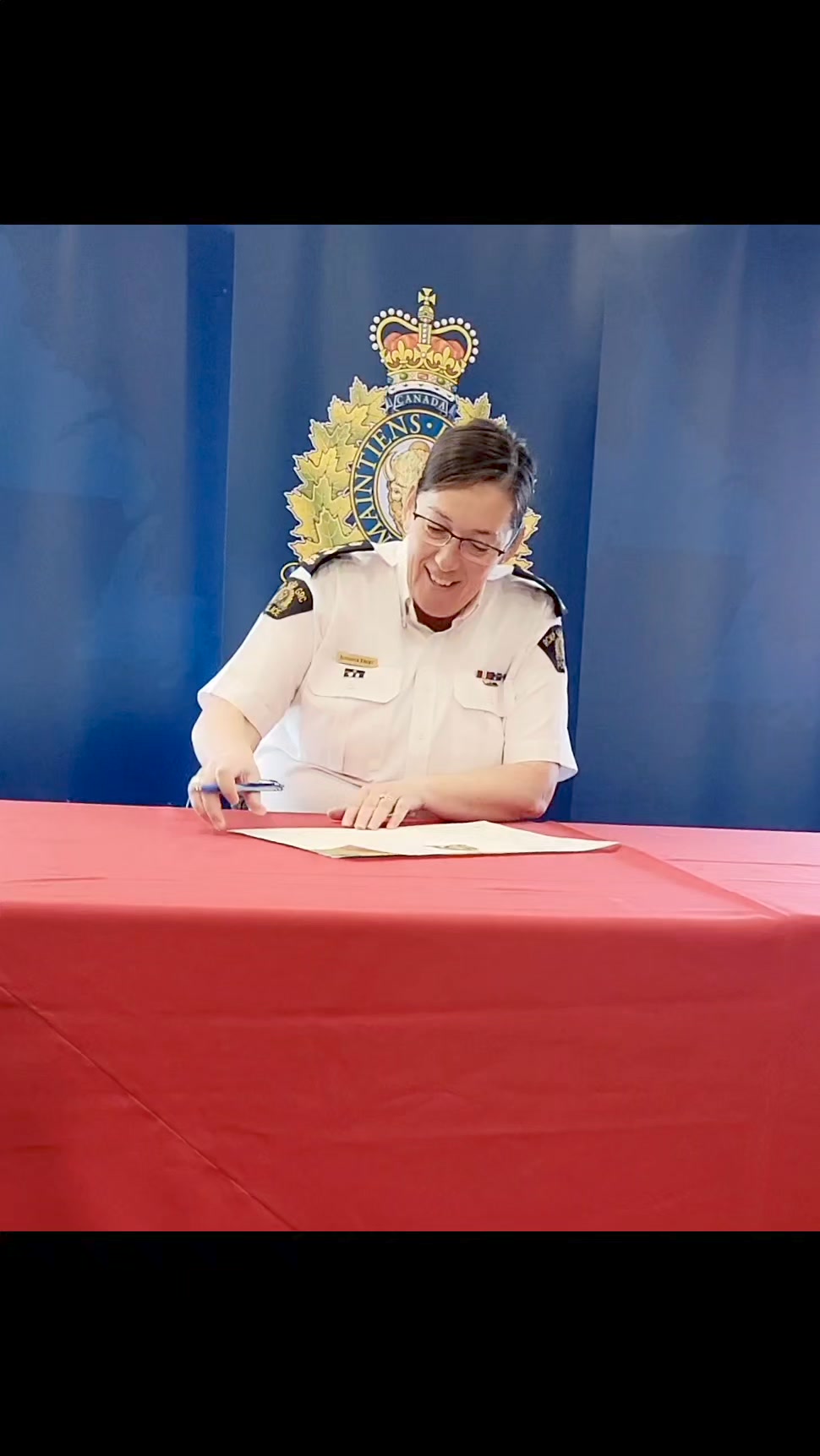 Assistant Commissioner Jennifer Ebert signs the declaration of the RCMP ...