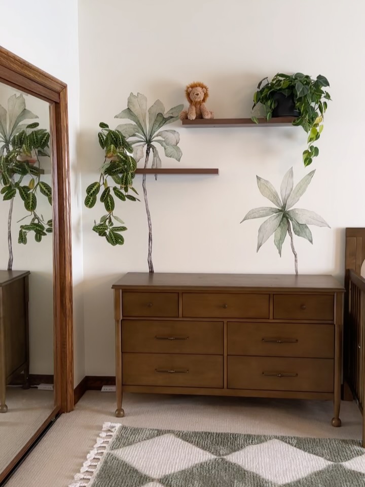 boho nursery dresser reveal! 🌴🌿✨We went with a neutral look with a soft tropical twist. A calm jungle theme without going overboard. The walnut and arched crib are from @namesake_home (love their nontoxic Hazelnut finish and
