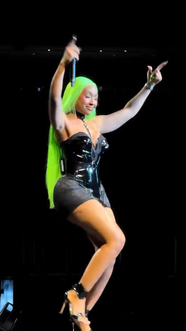 Yung Miami Performs in Atlanta in Black Latex Mini Dress and Green Hair