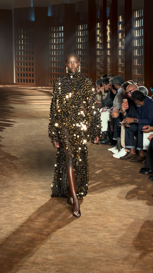 anok yai versace gold dress @anokyai, the supermodel you are. Today in Milan, she closed @ferragamo’s spring 2027 collection in a gown coated with paillettes after walking in a pale blue latex trench. | Harper's Bazaar anok yai gold