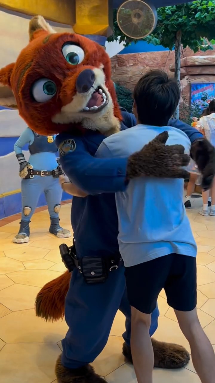 At Shanghai Disneyland, Nick and a lucky visitor spin in circles