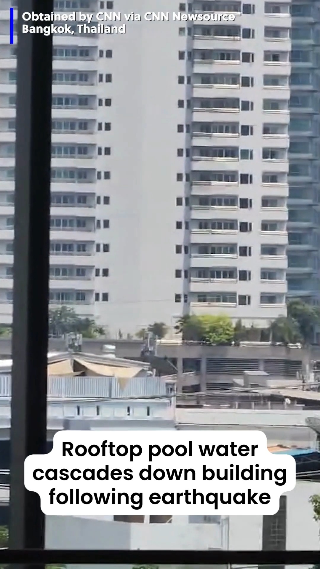 Pool water from a rooftop pool cascaded down a building in Bangkok ...