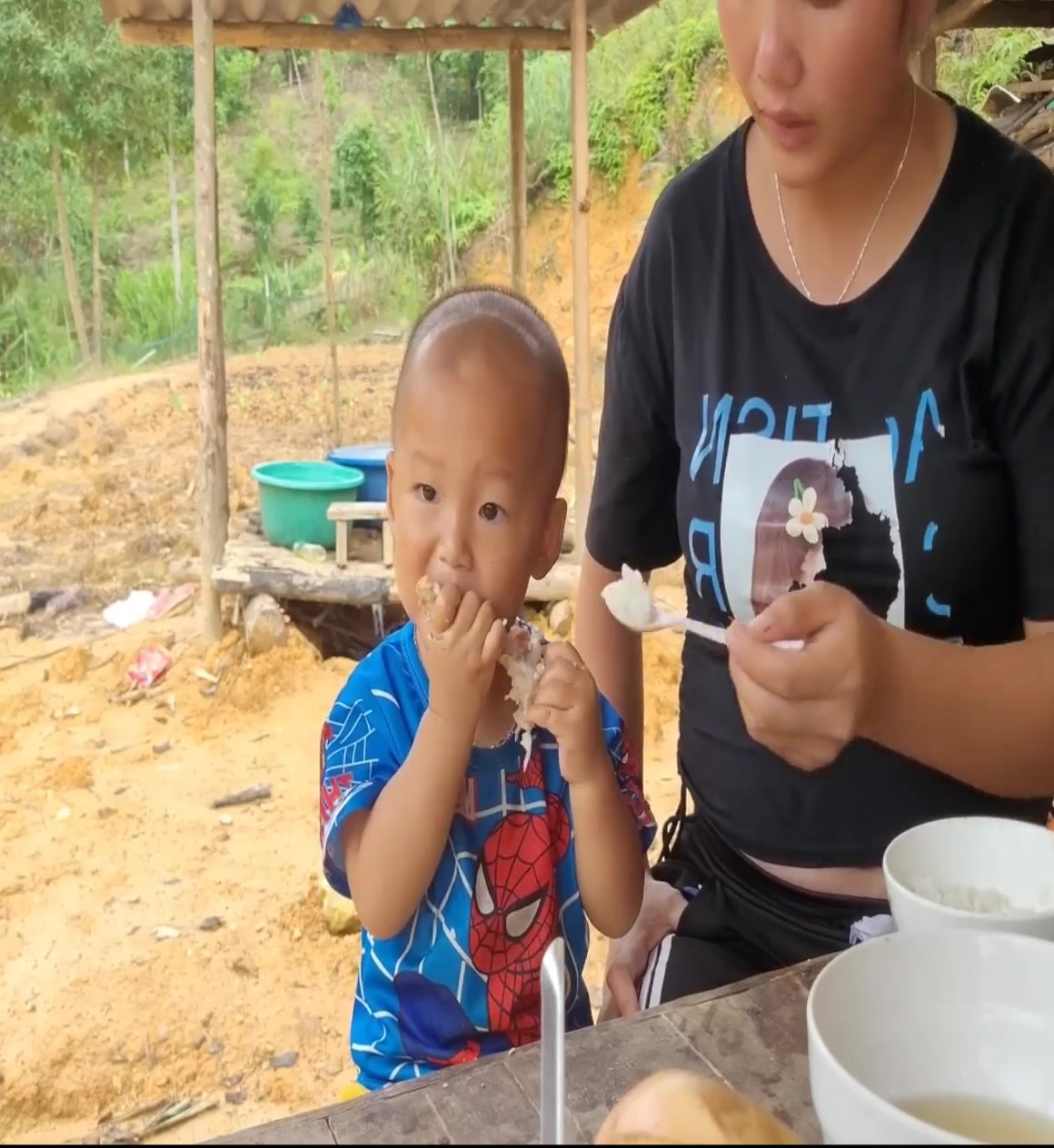 single mother about to give birth, bakes rice for a meal, plants more ...