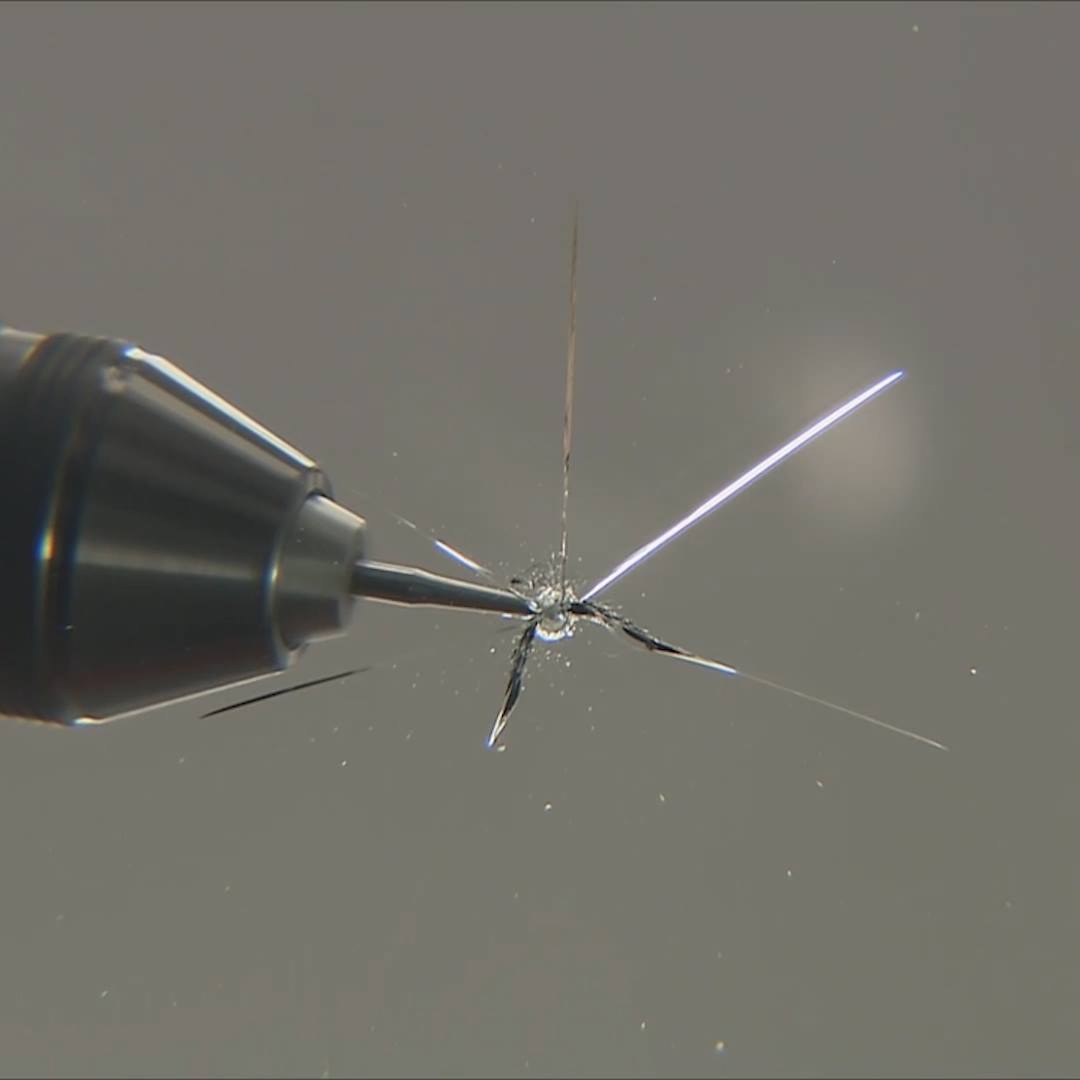 A needle and a razor blade are used to repair a cracked windscreen in ...