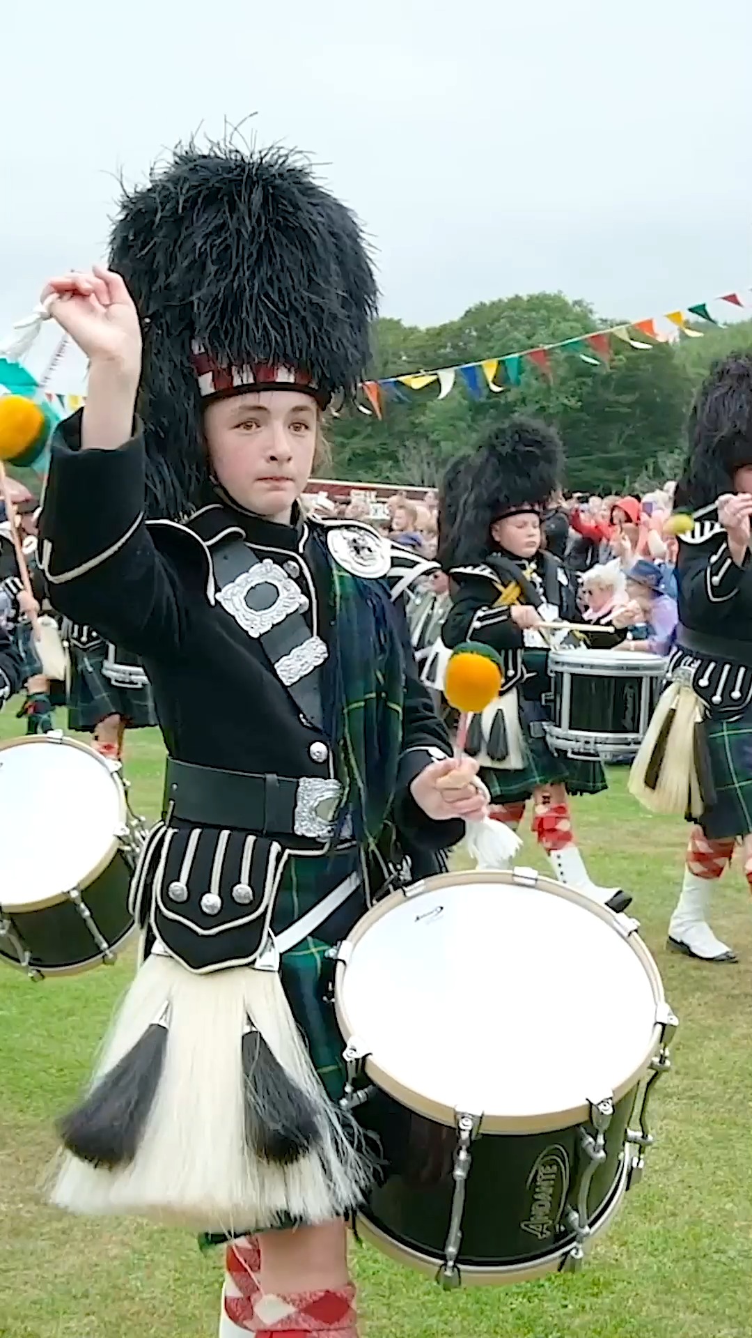 A close-up of the Lonach Highlanders, led by the Lonach Pipe Band ...
