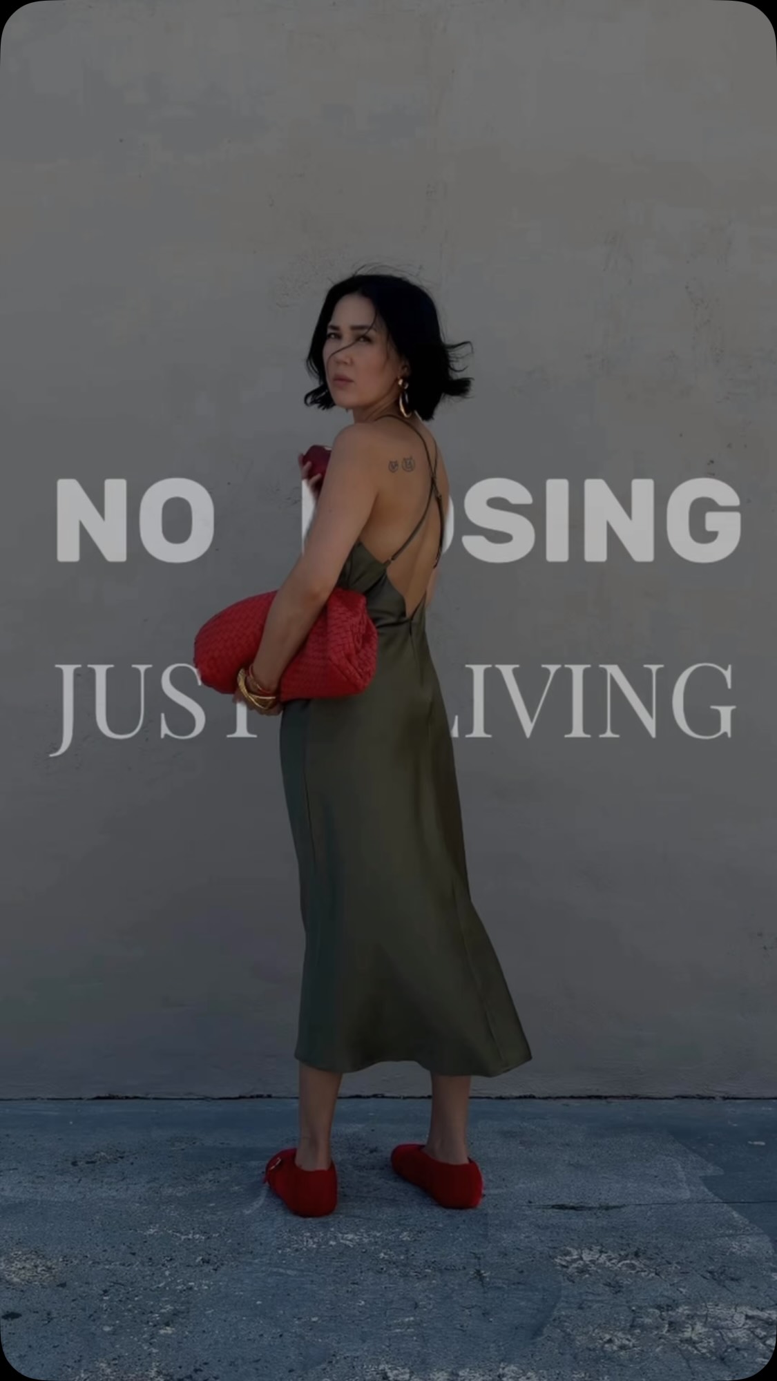 No posing. Just living - in an olive green satin dress from Lulus.com., Styled with red accessories for an effortless summer outfit with a little personality. 🍎, #ootd #lov