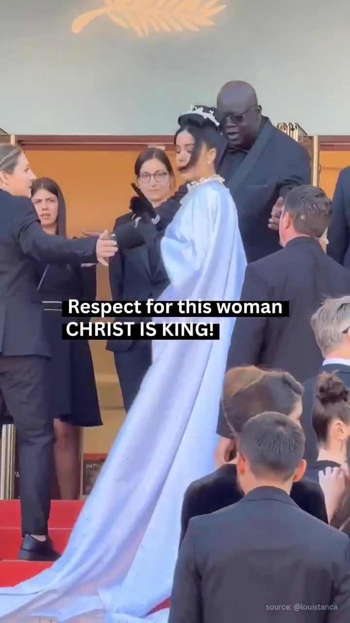 At the Cannes Film Festival, a woman walked the red carpet wearing a dramatic white gown printed with a large image of Jesus Christ wearing the crown of thorns. Security personnel and staff 