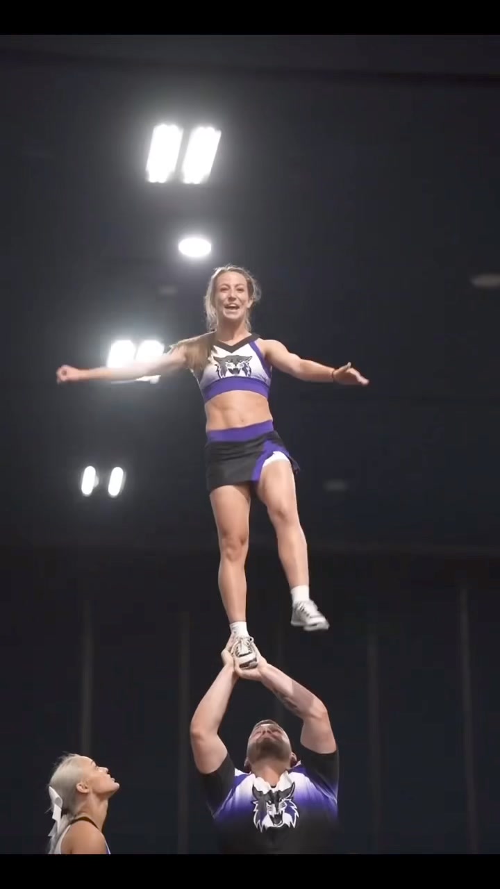 Kat and Michael performing their NCA Partner Stunt routine at a high ...