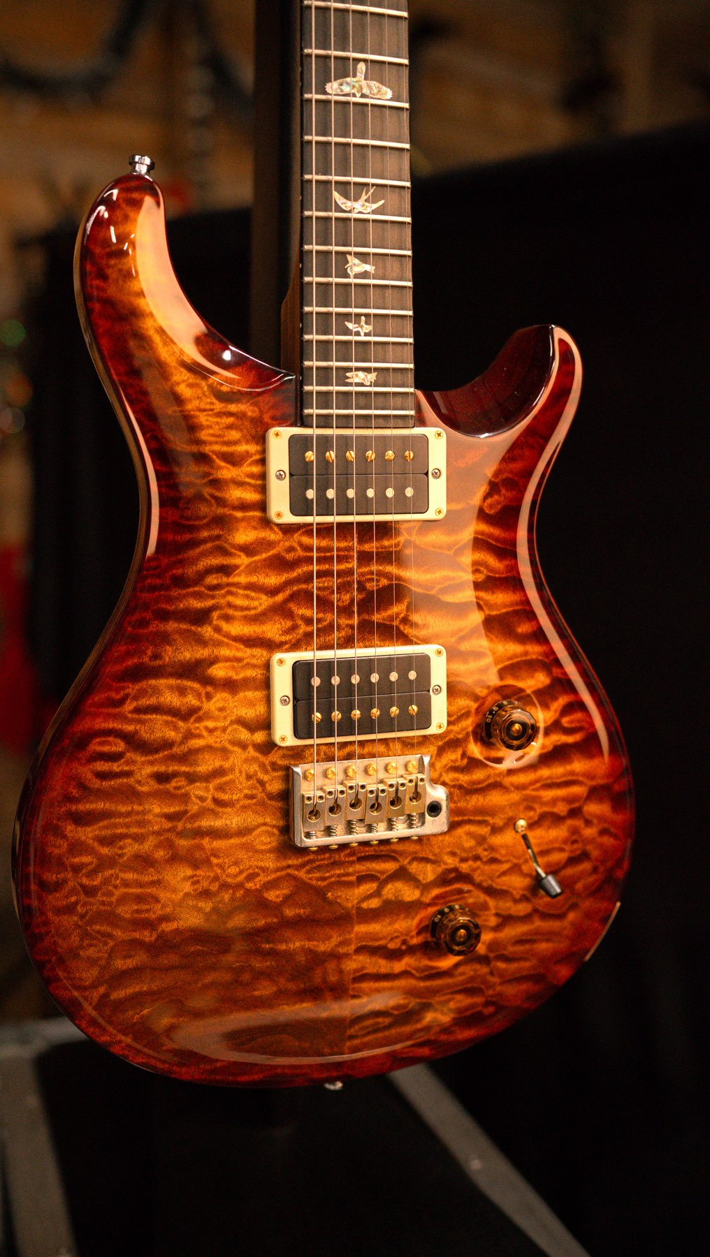 The PRS Custom 22 Artist Package in Burn Almond Quilt is an