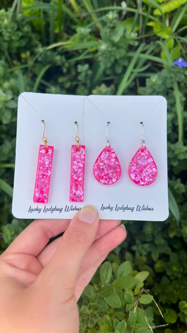 AMBUSH® original branded pill charms are suspended from an
